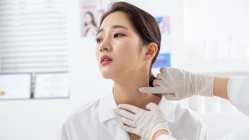 다미온의원 진료 장면 — 의료진이 얼굴 상태를 살피는 모습